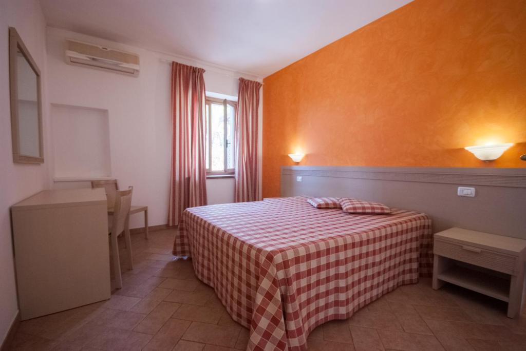 Łóżko lub łóżka w pokoju w obiekcie Residence Le Grazie Est