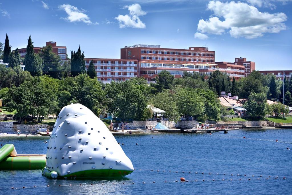 a white object in the water in a city at Hotel Albatros Plava Laguna in Poreč