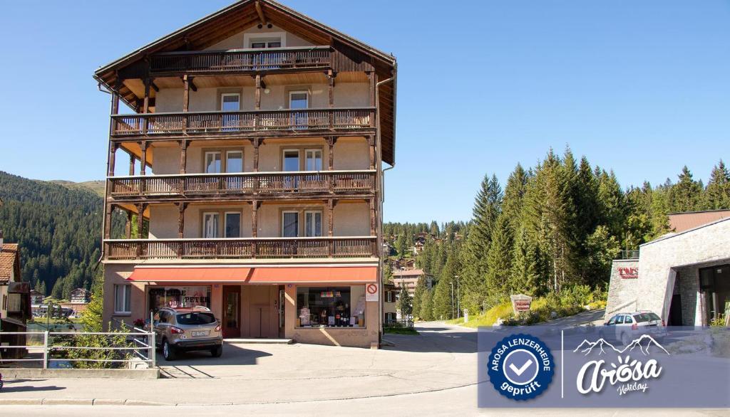 
a large building with a clock on the front of it at Haus Hermann in Arosa
