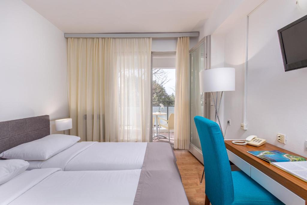 Postel nebo postele na pokoji v ubytování Hotel Zagreb