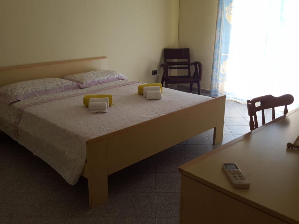 a bedroom with a bed with two yellow pillows on it at Casa O'Scia in Lampedusa