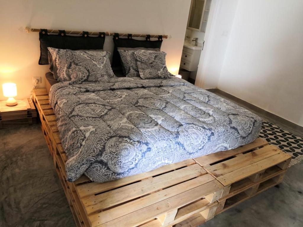 a bed made out of a wooden pallet at The Blue Gate 2 in Muscat