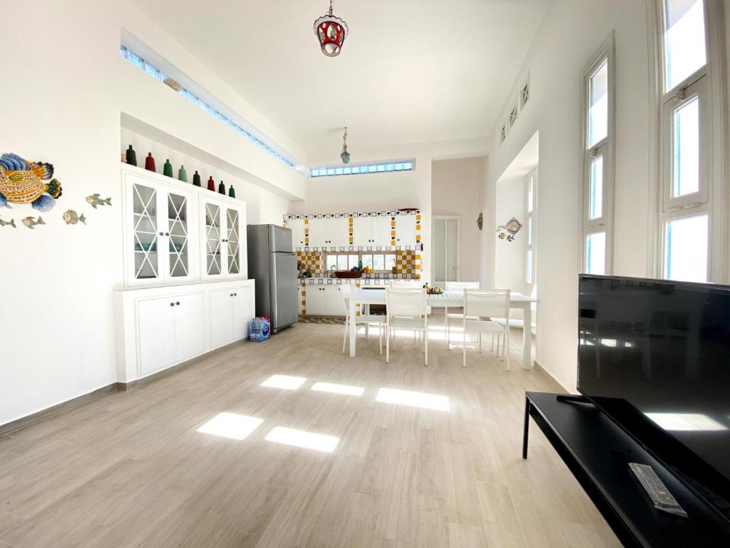 cocina y sala de estar con mesa y sillas en I Reitani San Lorenzo, en Reitani
