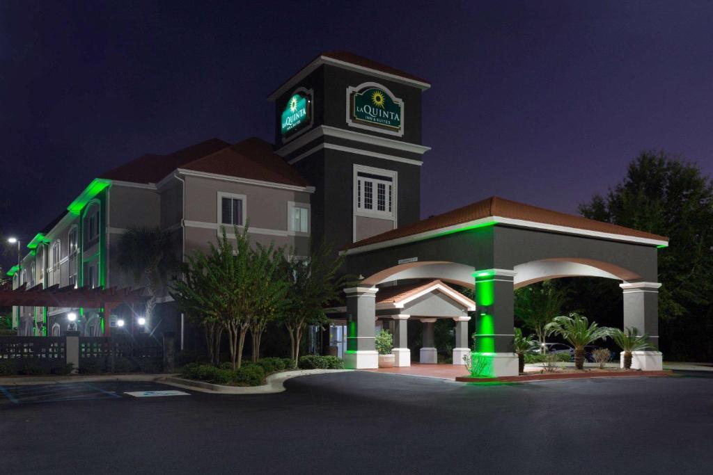 a building with a clock tower at night at La Quinta by Wyndham Mobile - Daphne in Daphne