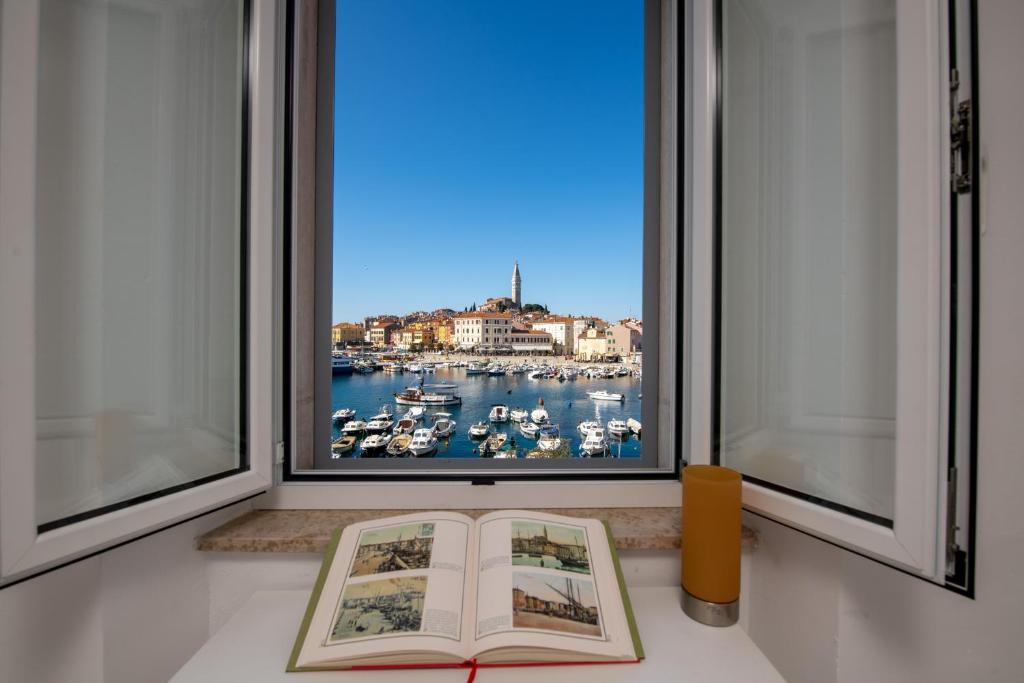a book sitting on a counter in front of a window at Island sea view in Rovinj