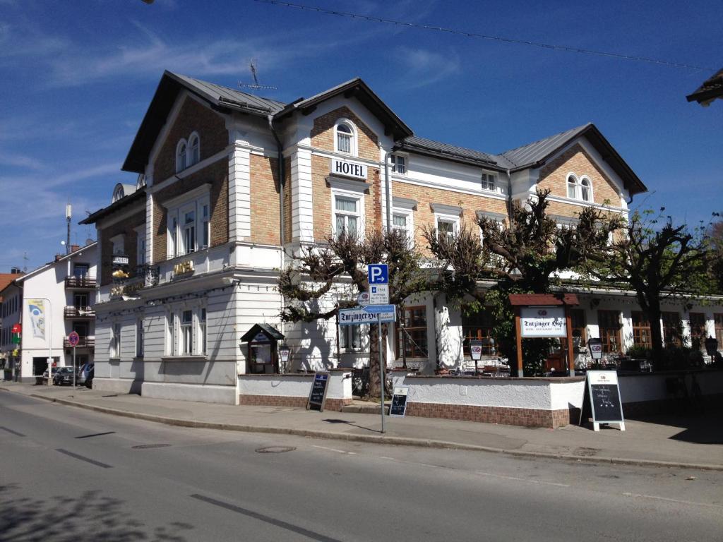 a large building on the corner of a street at Tutzinger Hof in Tutzing