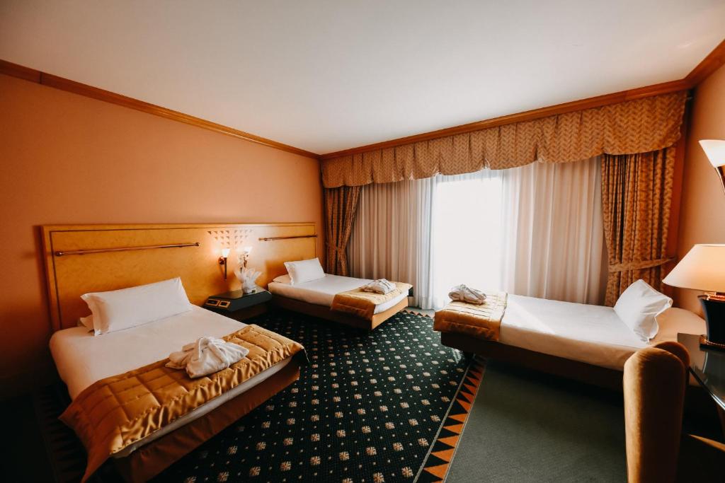 Postel nebo postele na pokoji v ubytování SHG Hotel Antonella