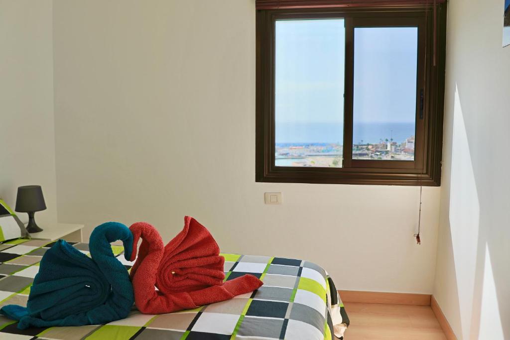 En eller flere senger på et rom på Paradise Ocean View