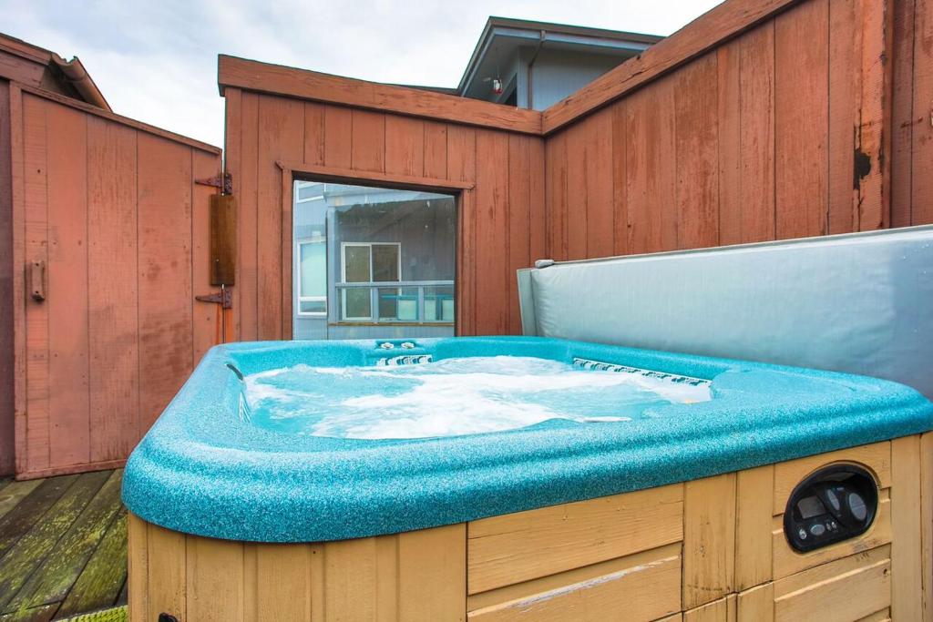 a hot tub sitting on top of a wooden building at Abalone Alcove! Hot Tub! Pool Table! AMAZING VIEWS! Fast WiFi!! Dog Friendly! in Dillon Beach