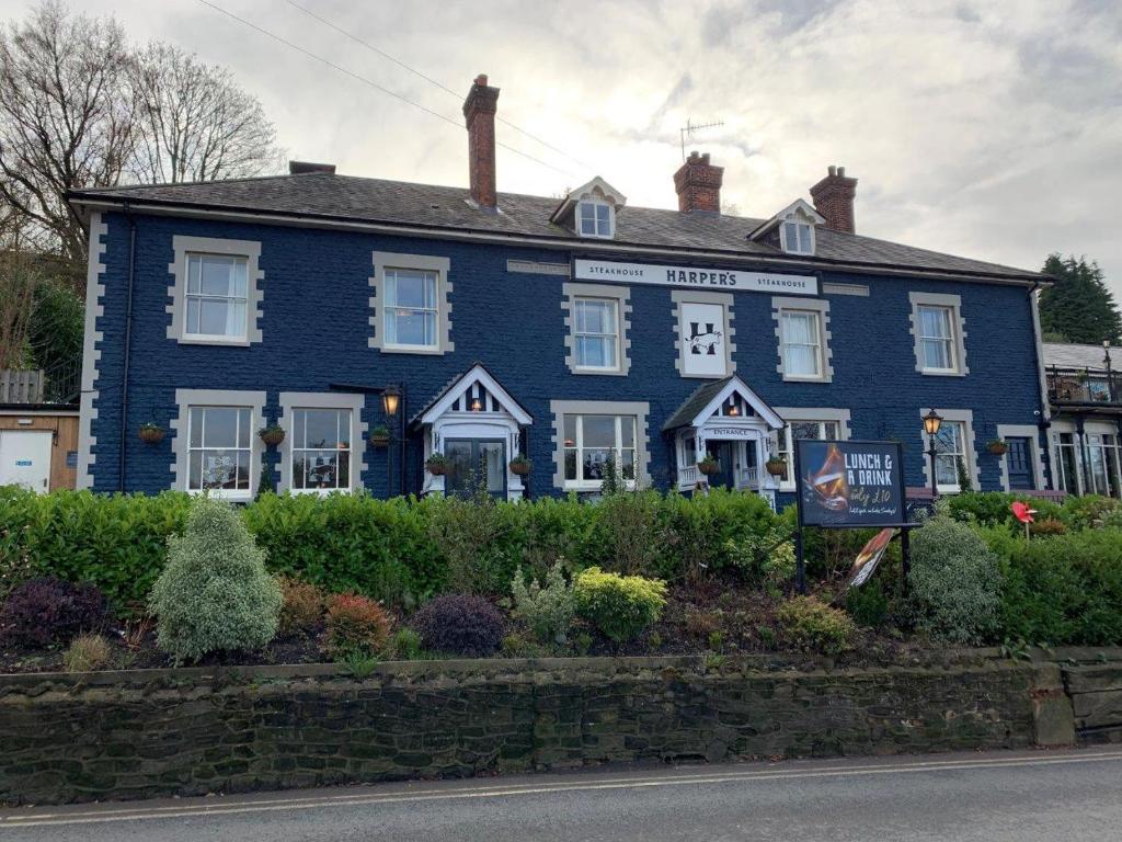 a blue house on the side of a street at Harper's Steakhouse with Rooms, Haslemere in Haslemere