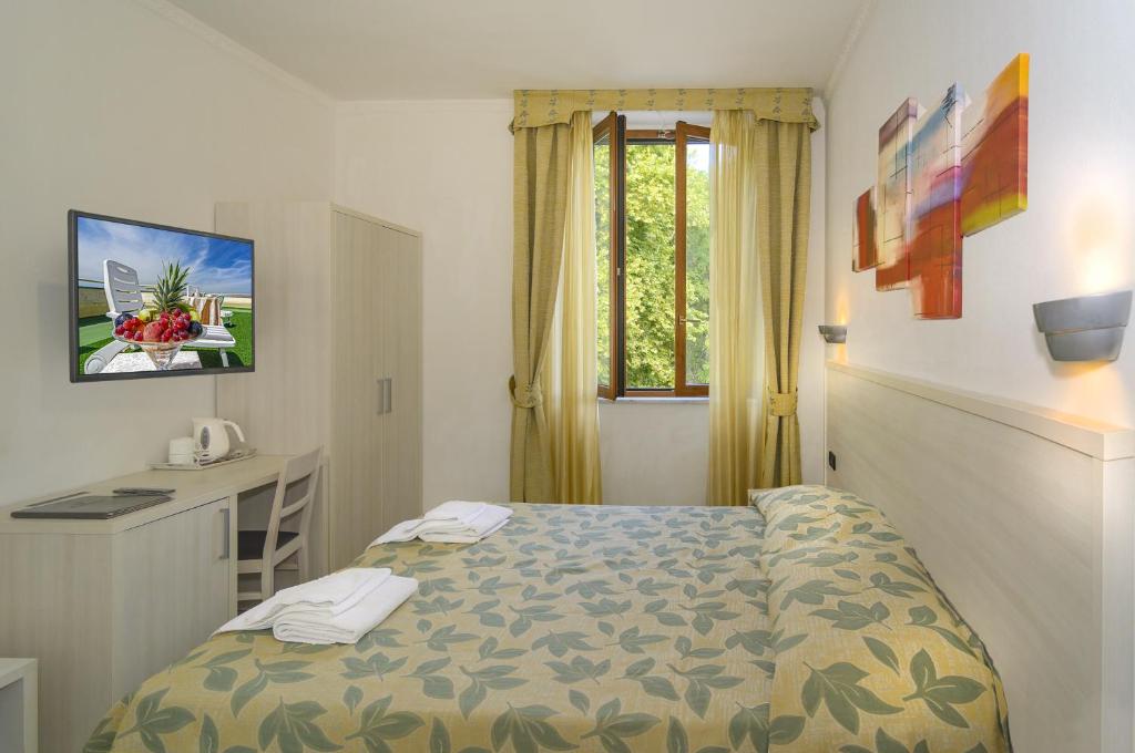 Postel nebo postele na pokoji v ubytování Hotel Vittoria