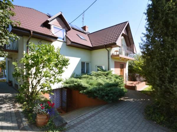 a house with a brick driveway in front of it at Agroturystyka Nad Bugiem Szuminka in Szuminka