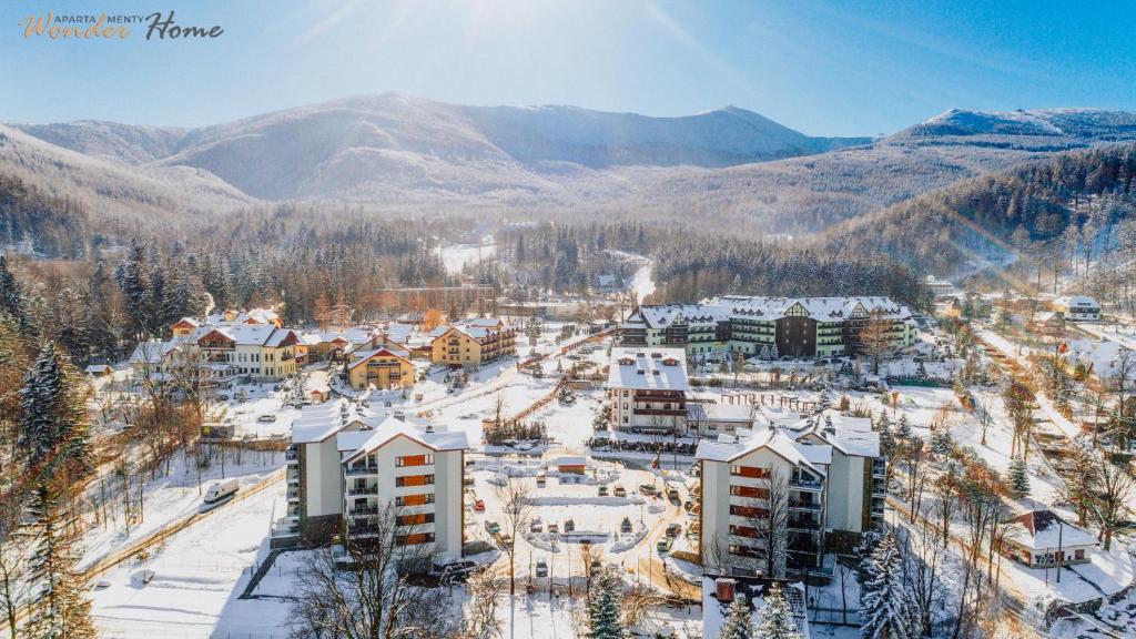 an aerial view of a resort in the snow at Wonder Home - Apartamenty z balkonami, blisko centrum Karpacza, stoku i aquaparku in Karpacz