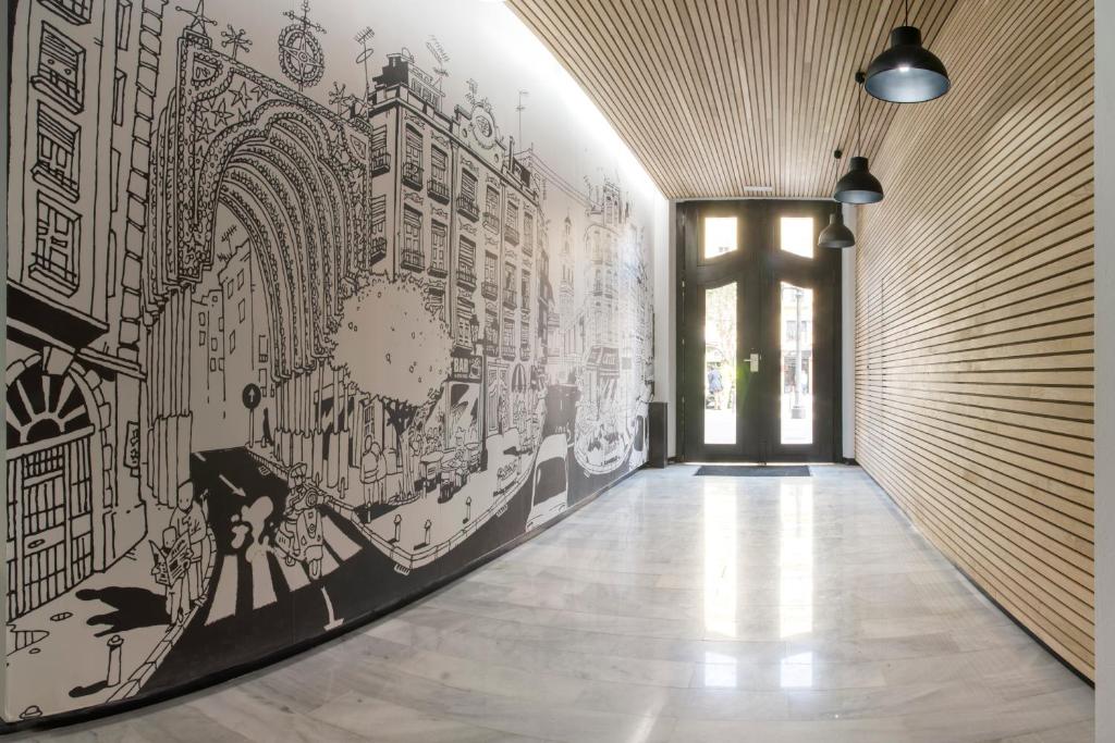 a hallway with a mural on the wall at El 16 Ruzafa in Valencia