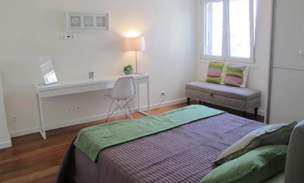 a white bedroom with a bed and a desk at Plaka Sweet House 2 in Athens