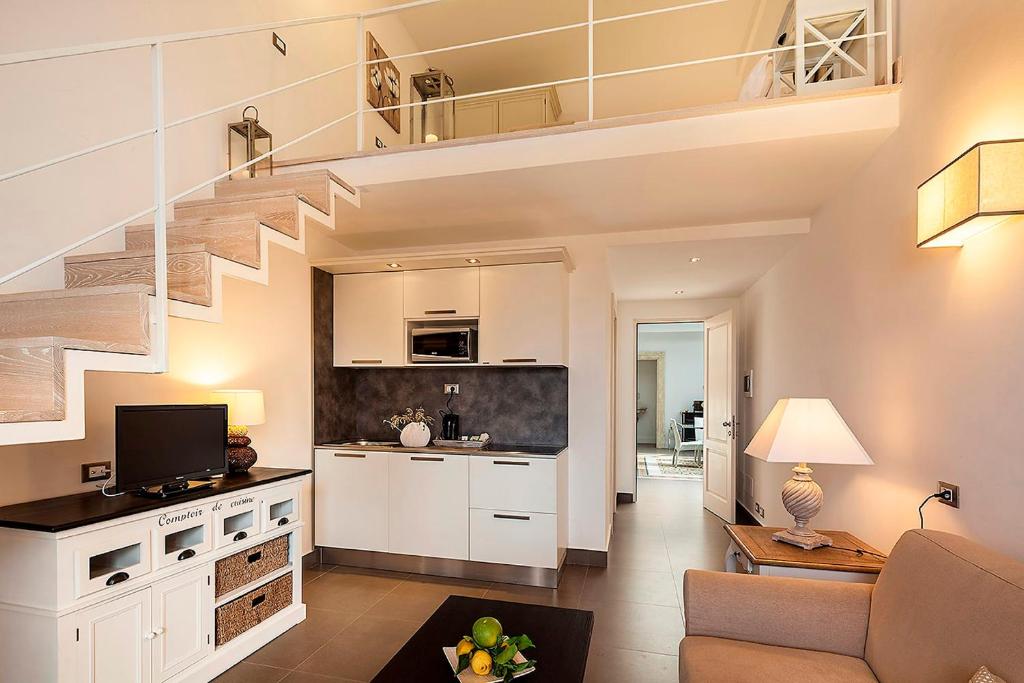 a living room with a staircase and a kitchen at Tenuta Del Poggio Antico in Ischia