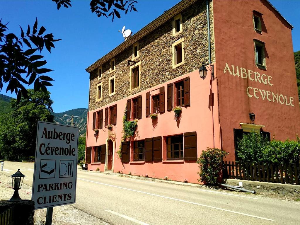 un edificio con un letrero al lado de una calle en Auberge Cevenole, en Valleraugue