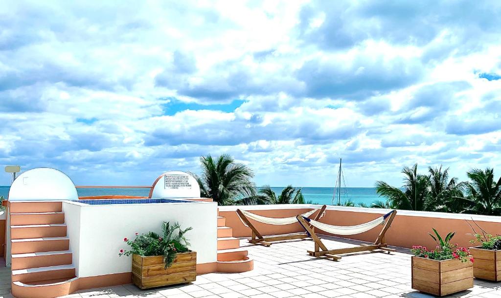 a balcony with chairs and a view of the ocean at Seaside Villas in Caye Caulker