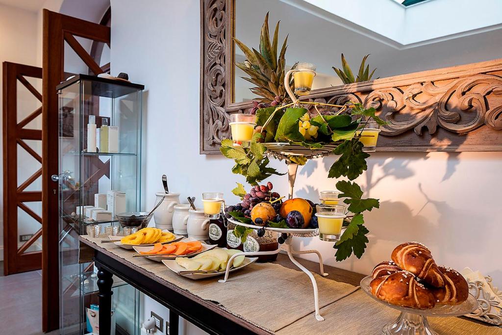 a table with a bunch of fruits and vegetables on it at Tenuta Del Poggio Antico in Ischia