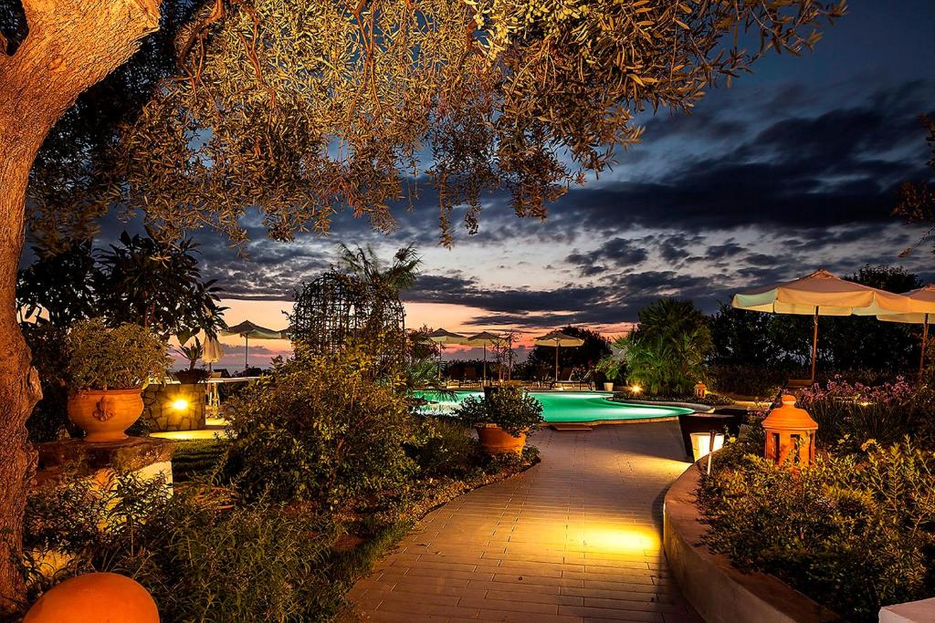 a night view of a swimming pool at a resort at Tenuta Del Poggio Antico in Ischia