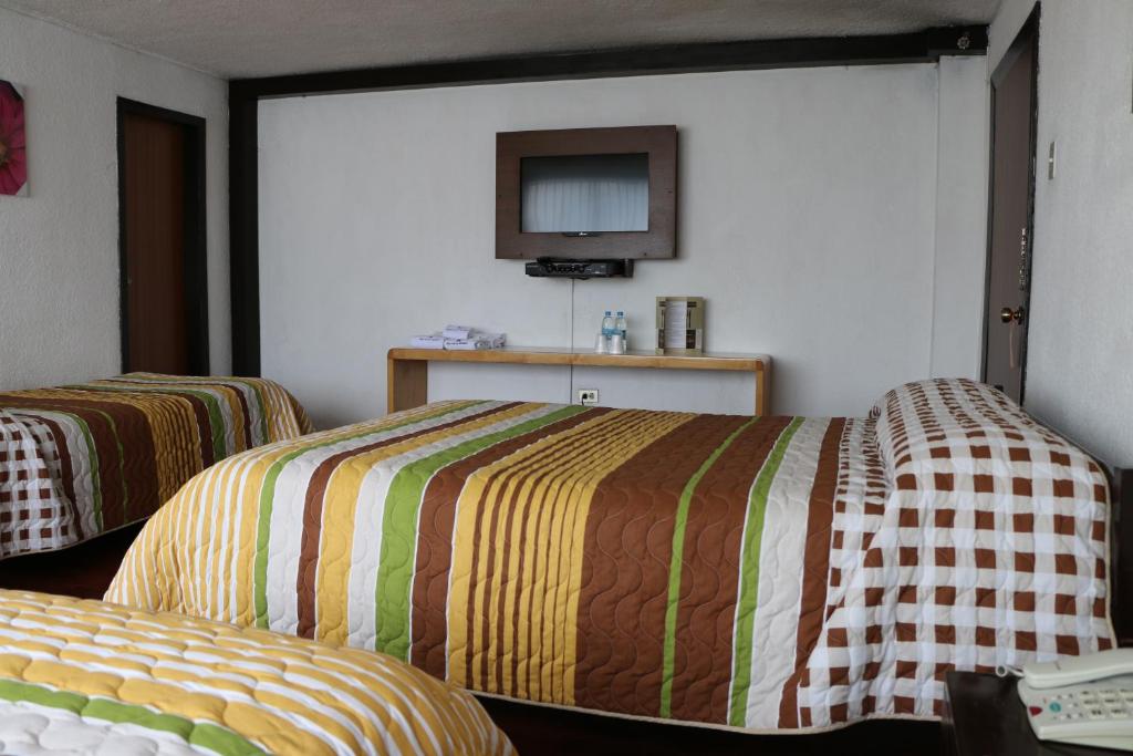 Postel nebo postele na pokoji v ubytování Hotel 6 De Diciembre