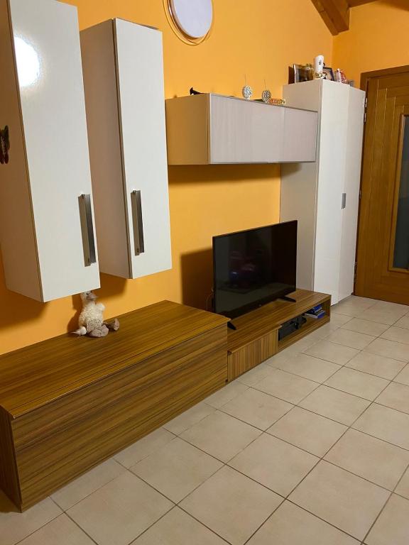 a living room with a television on a wooden entertainment center at Cozy home in Pertegada