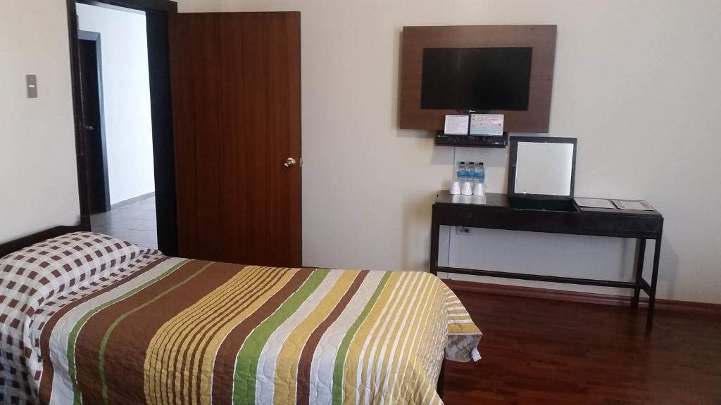 Postel nebo postele na pokoji v ubytování Hotel 6 De Diciembre