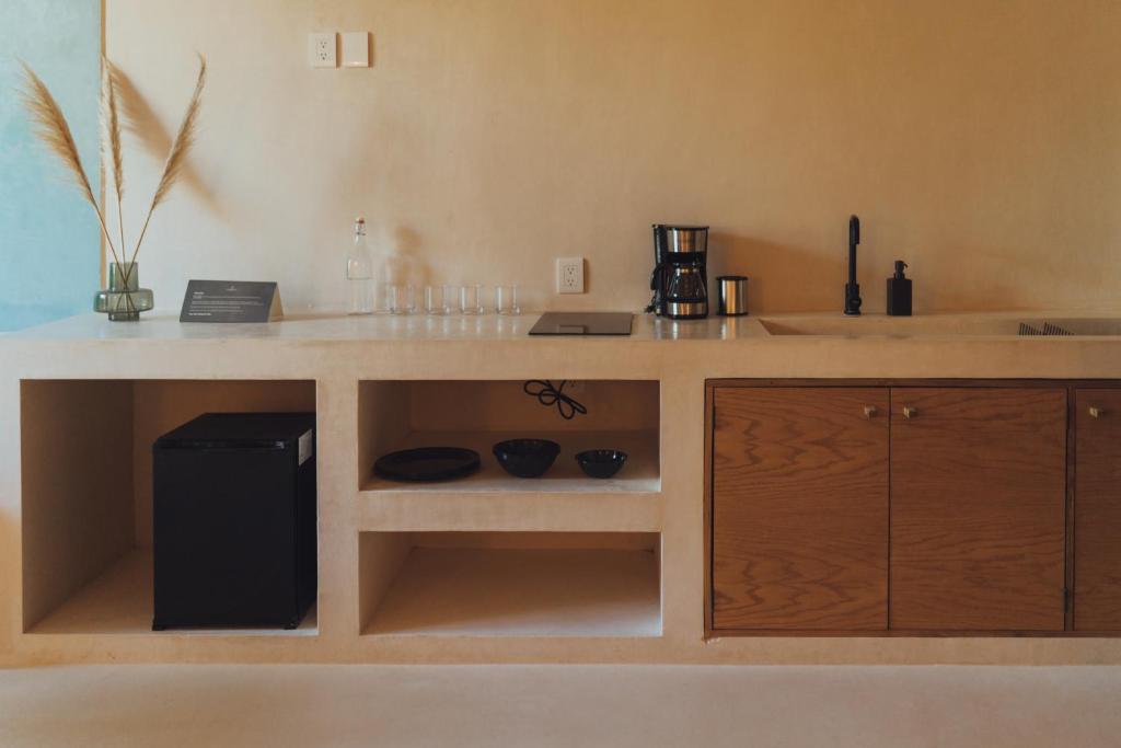 a kitchen with a counter with a sink and a counter at Casa Peregrino Holbox in Holbox Island