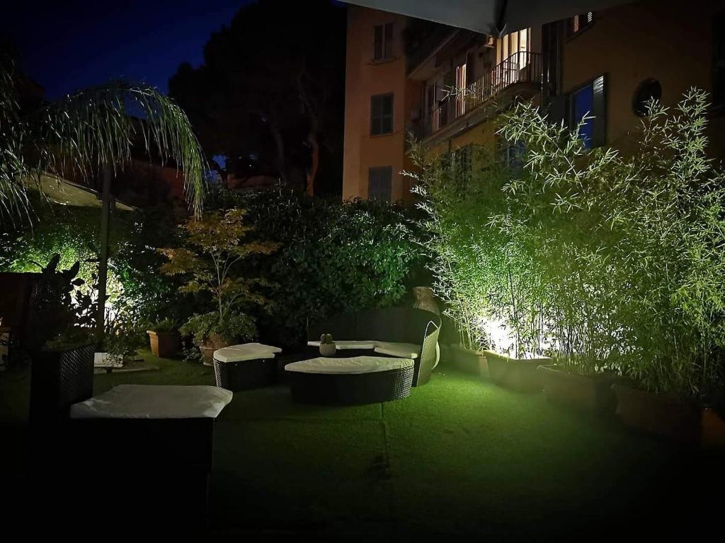 a garden at night with chairs and tables and trees at Hotel Coppede' in Rome