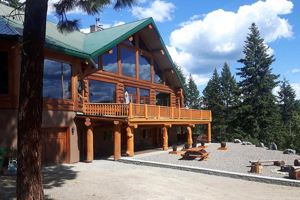 a large wooden house with a balcony on it at Spirit Lodge at Silverstar in Vernon