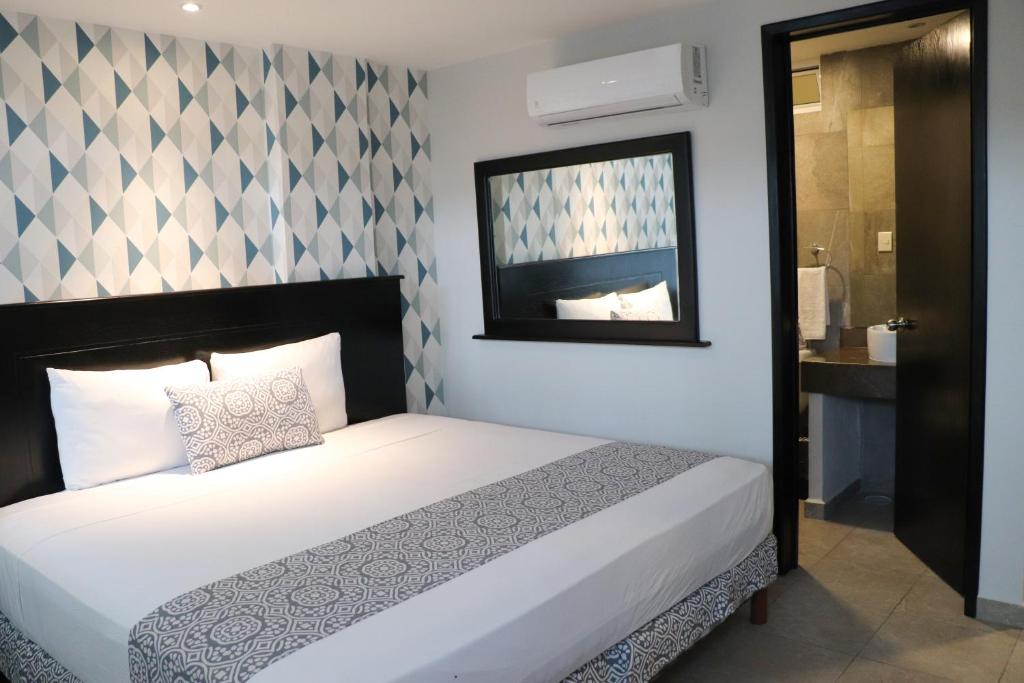 Postel nebo postele na pokoji v ubytování Hotel Costa Verde