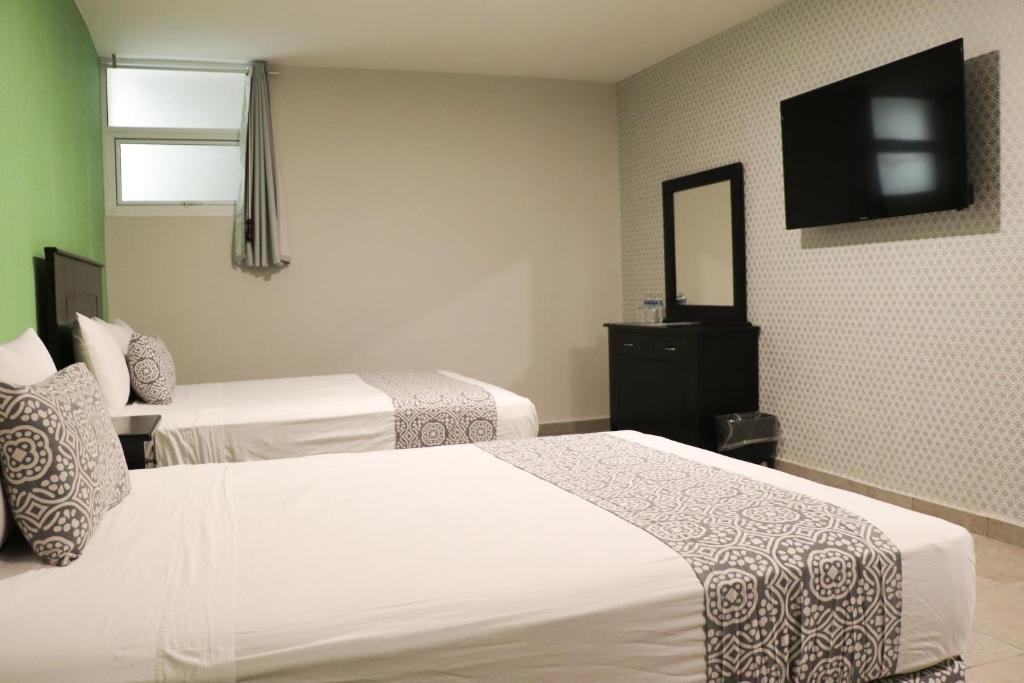 Postel nebo postele na pokoji v ubytování Hotel Costa Verde