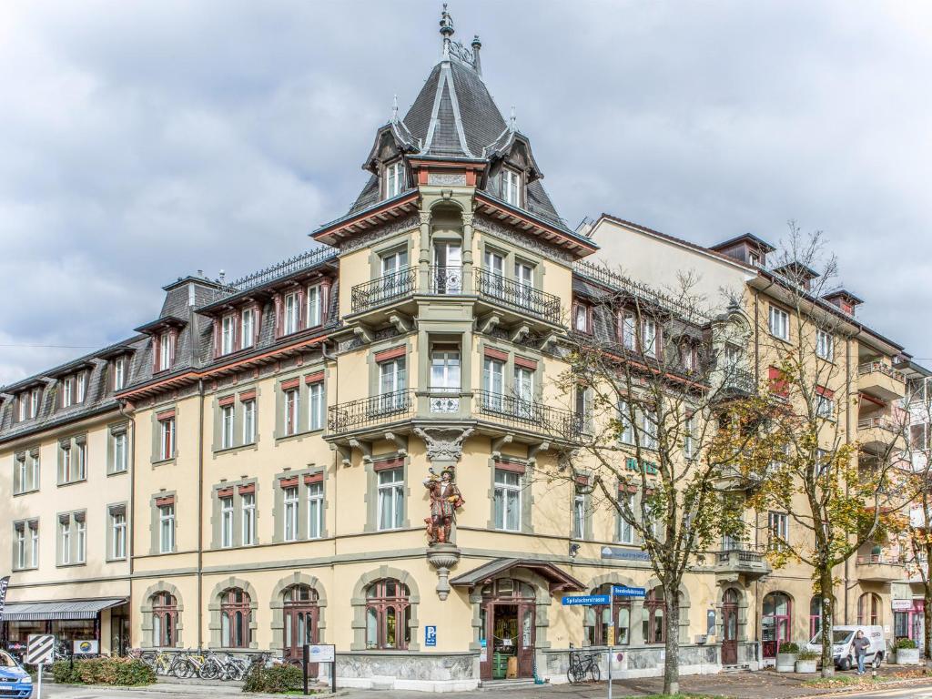 a large building with a tower on top of it at Hotel Waldhorn in Bern