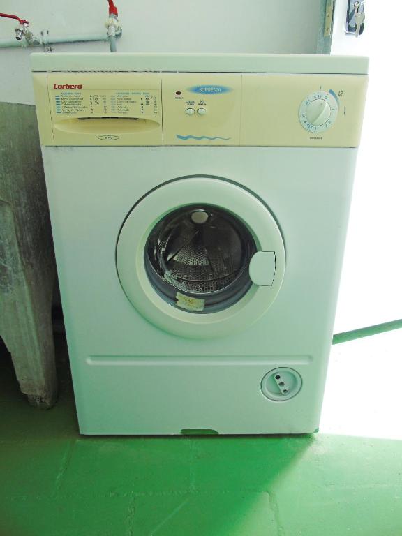 a washing machine with its door open in a room at Fleitas Penthouse with terrace in San Andrés