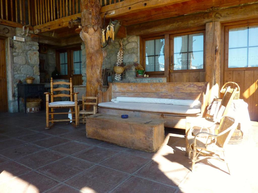 a room with a bed and chairs in a cabin at Casa rural calRei in Lles