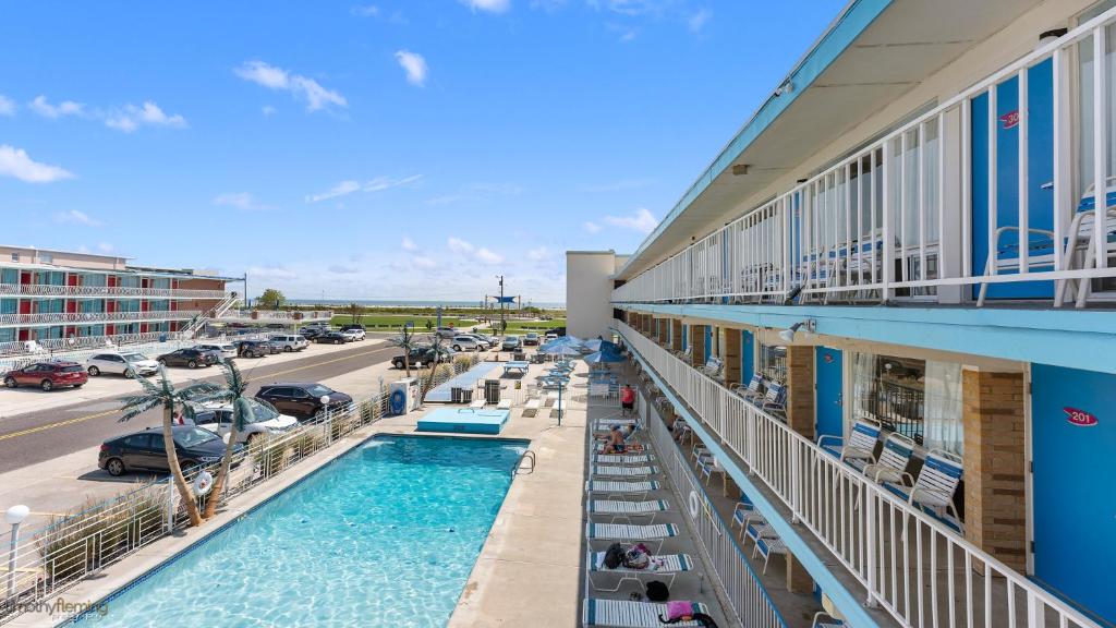 a view of a hotel with a pool and a parking lot at Cara Mara Resort in Wildwood Crest