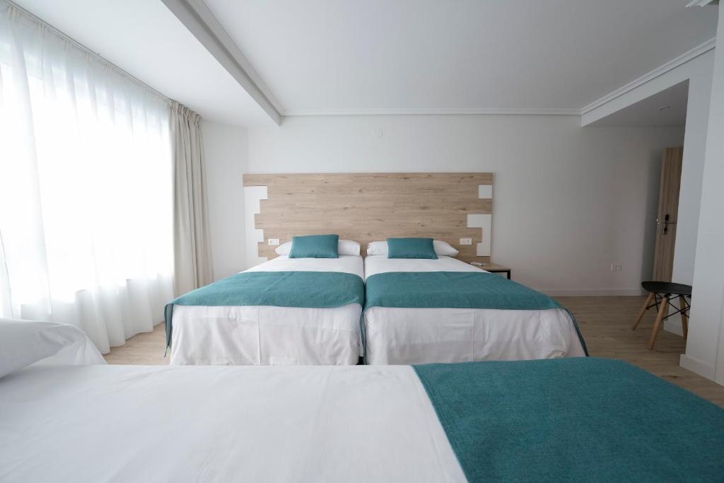 Posteľ alebo postele v izbe v ubytovaní Hotel VIDA Finisterre Centro
