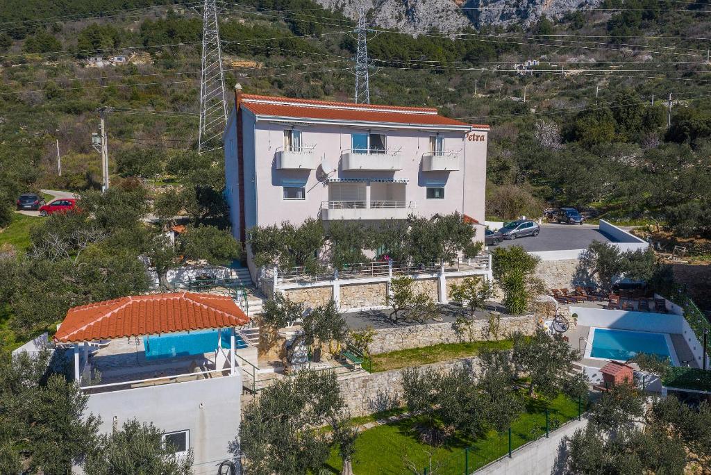 an aerial view of a house in a mountain at Apartment Glavina with private pool in Makarska