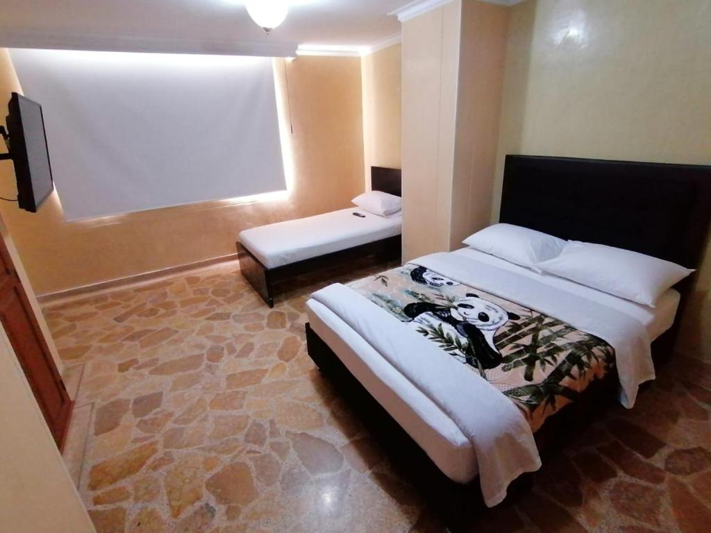 Postel nebo postele na pokoji v ubytování HOTEL GOLDEN SUITE