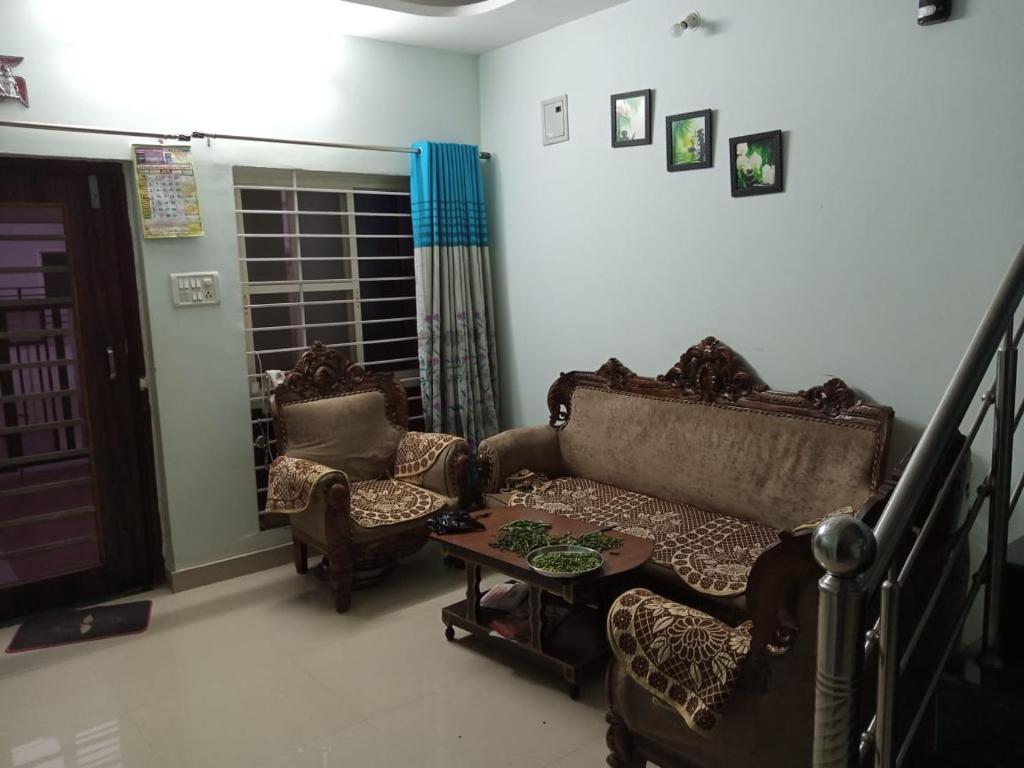 a living room with a couch and chairs and a table at Nand Villa 2Bhk in Bharbharia