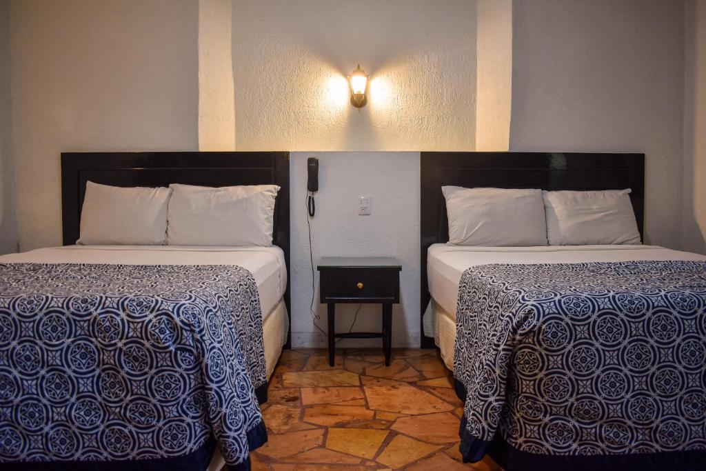 Postel nebo postele na pokoji v ubytování Hotel Santa Ana