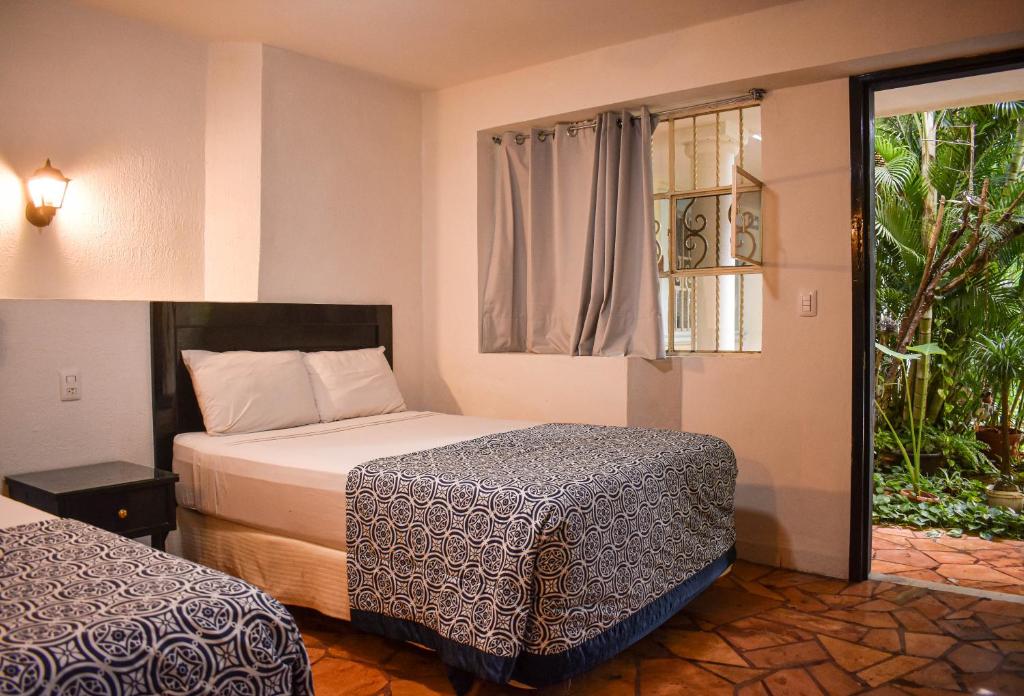 Postel nebo postele na pokoji v ubytování Hotel Santa Ana
