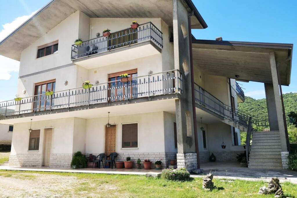Una gran casa blanca con gente en los balcones en Casa Ivan en San Giorgio a Liri