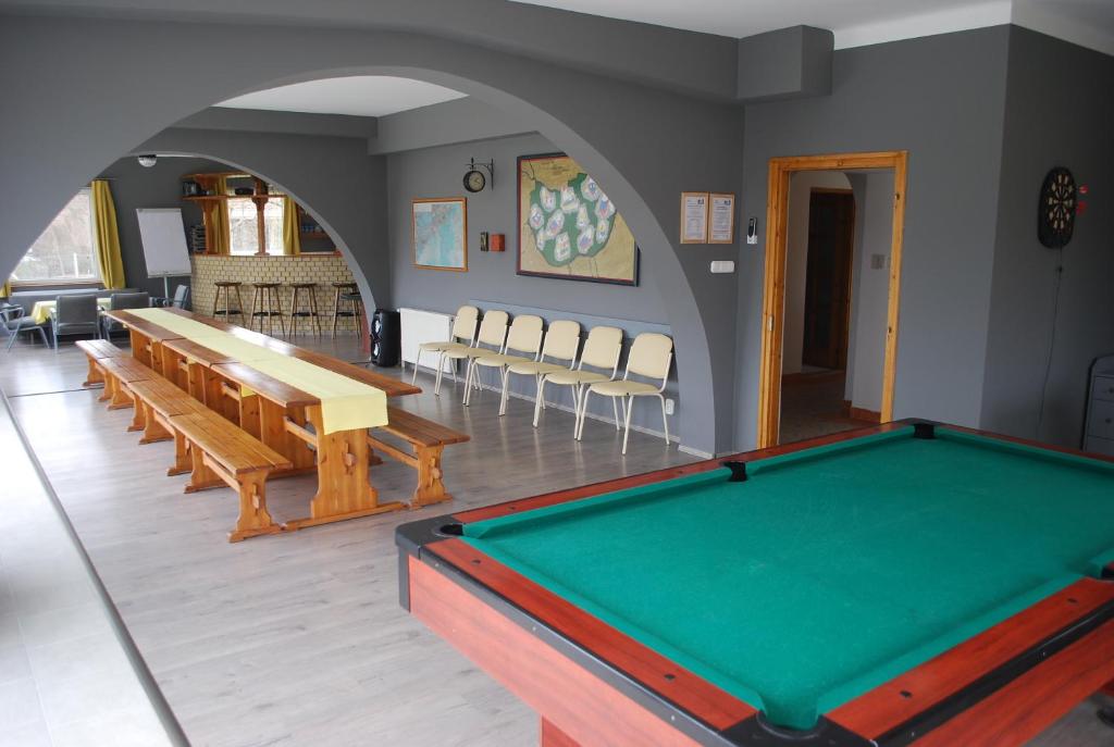 a room with a pool table and chairs at Casa Napsugár Panzió in Apostag