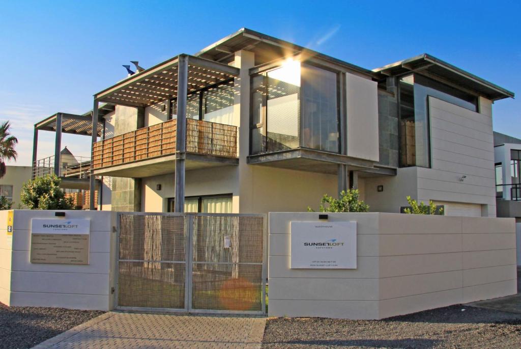 a house with a sign in front of it at Sunset-Loft in Cape Town
