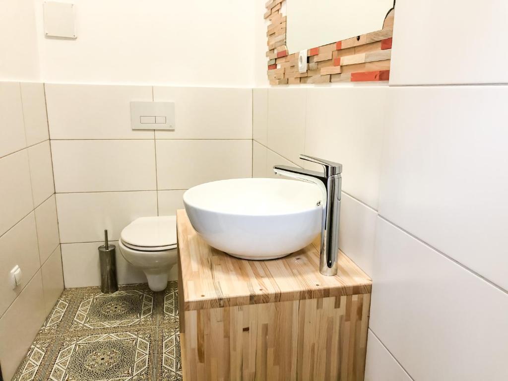 a bathroom with a sink and a toilet at Kisas Loft By Pinch in Pakoštane