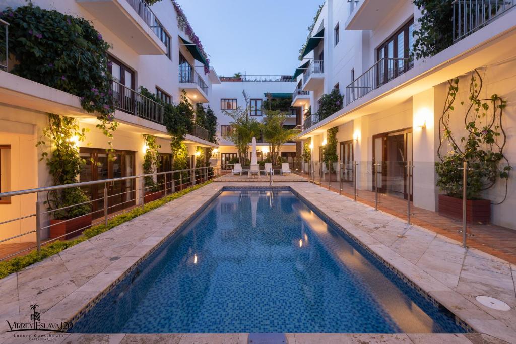 a swimming pool in the middle of a building at Casa Virrey Eslava 120 inside the Walled City of Cartagena in Cartagena de Indias