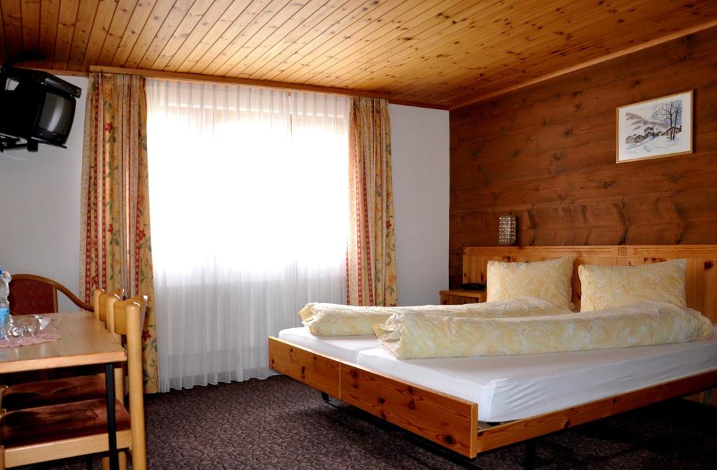 Postel nebo postele na pokoji v ubytování Hotel Tenne