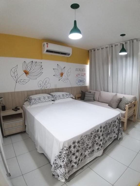 a bedroom with a large bed and a couch at Smart Residence Flat - FLAT 605 in Teresina