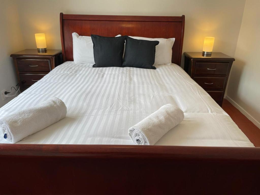 a bedroom with a large bed with two towels on it at 3 BR Family House close to Melbourne Airport in Melbourne